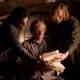 Fenoglio (JIM BROADBENT, middle) finds his original manuscript for Inkheart as Mo (BRENDAN FRASER, left) and Dustfinger (PAUL BETTANY, right) anxiously grab at the pages in New Line Cinema's fantasy adventure 'Inkheart,' also starring HELEN MI