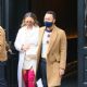Chrissy Teigen – In thigh-high pink boots and a white dress out in New York