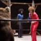 Andy Richter (center left) as “Bobby Dee” and “Clarence ‘Coffee Black’ Withers”, played by Andre Benjamin (center) look on as “Jackie Moon”, played by Will Ferrell (right) prepares to wrestle Dewie the Kille